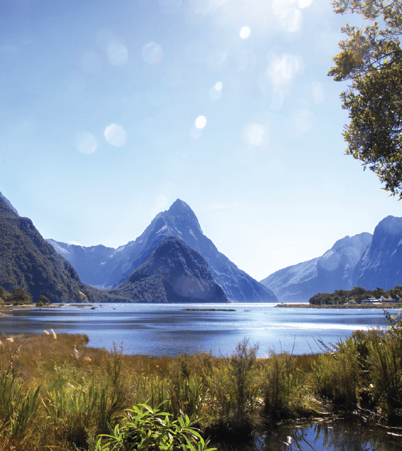 Looking across the waters of the Fiord to Mitre Peak on a sunny day in Milford Sound